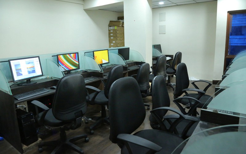 An office space with multiple computer stations and seating arrangements.